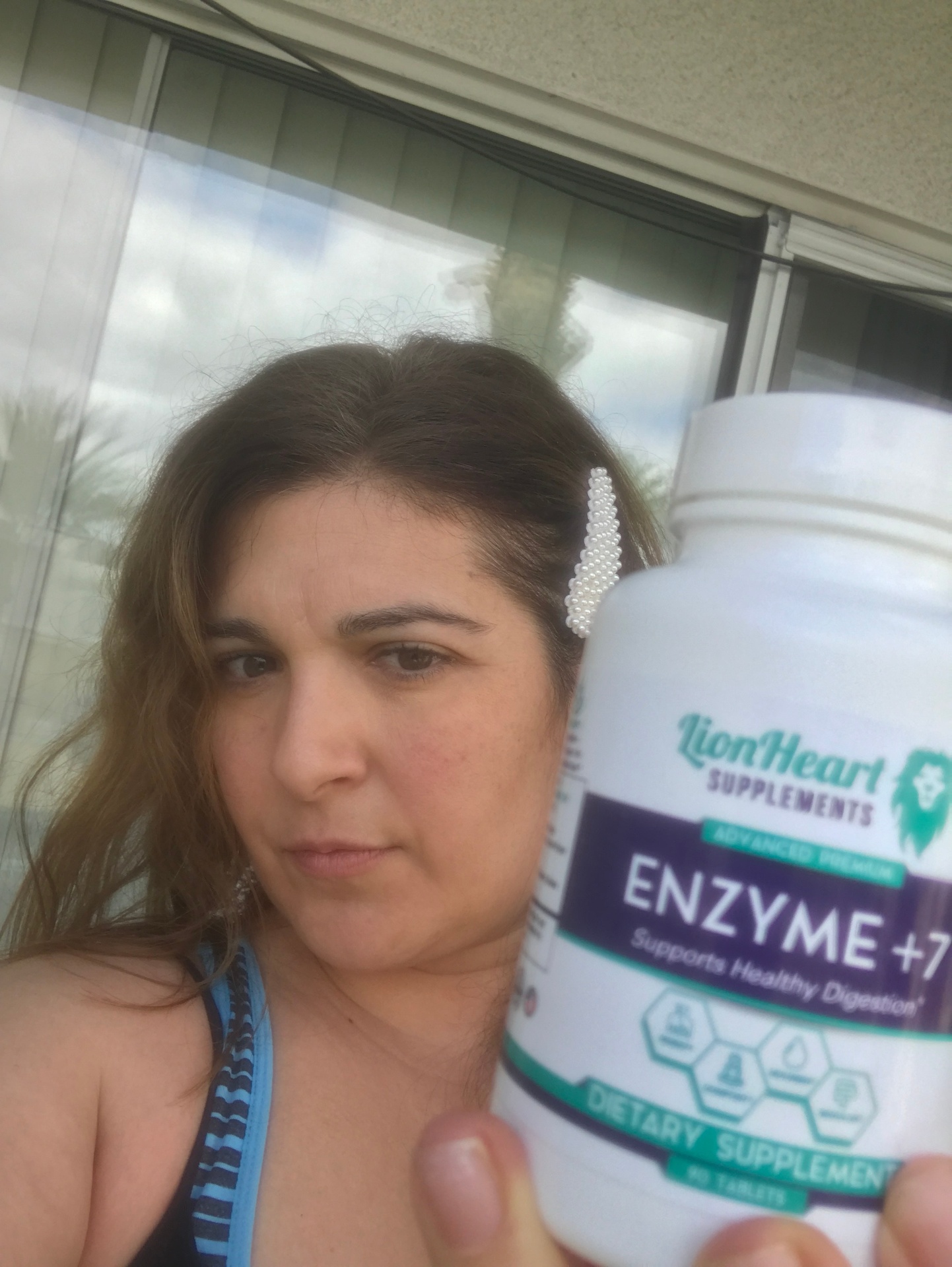 Maria L. holding LionHeart Enzyme + 7